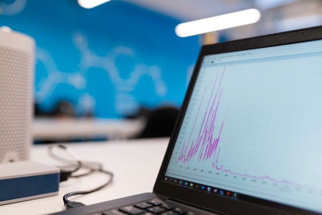 Laptop displaying a data analysis graph in a technology workspace — stock photograph